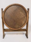 An early 20th century oak Revertable folding circular occasional table, diameter 61 cm.
