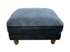 A contemporary footstool in navy blue upholstery, width 83 cm.