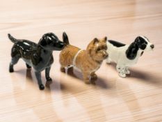 Three Beswick china dog figures : Cairn Terrier, Spaniel & Black Labrador.