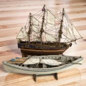 A scale model three masted ship, length 59 cm, and a further model lifeboat.