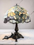 A patinated metal Tiffany-style leaded glass mushroom table lamp, height 65 cm.