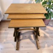 A 20th century teak nest of three tables with curved understretchers, width 56 cm.