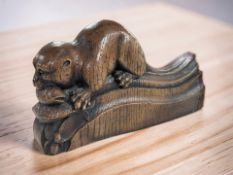 An Oak Apple Designs carved oak figure of an otter,