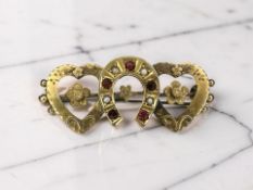 A late Victorian 9ct gold garnet and pearl brooch, width 3.5cm CONDITION REPORT: 2.