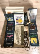 An Acorn Electron keyboard and various boxed games.