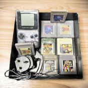 A Nintendo Gameboy Colour Model CGB-001, with power lead and various game cartridges.