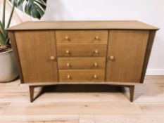 A 20th century teak inverted bow front sideboard, 137 cm x 47 cm x 85 cm.