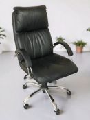A metal framed black vinyl swivel armchair