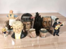 A group of character jugs including Beswick, a Wade figural decanter, etc.