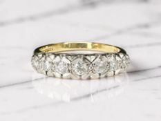 An 18ct gold seven stone diamond illusion-set ring, the stated total diamond weight 0.