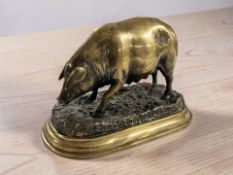 A cast brass figure of a pig on plinth, length 24 cm.