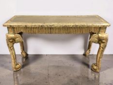 An Indian gilt and jeweled console table on elephant supports, 127 cm x 47 cm x 74 cm.
