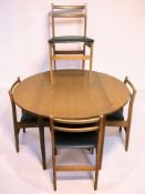 A 20th century teak circular drop leaf dining table, extended 114 cm diameter,