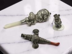 A Victorian silver Mr Punch rattle together with further an antique silver rattle and silver teddy