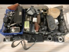 A collection of vintage film and digital cameras including Kodak Retina Reflex S, Olympus OM10,