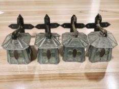 Four Arts & Crafts style stained and leaded glass wall lights with metal brackets,
