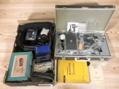 A Kowa SL slit lamp microscope, in carry case, together with an Olympus OM20 35mm film camera,
