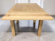 An Oak Furnitureland contemporary oak draw leaf extending dining table,