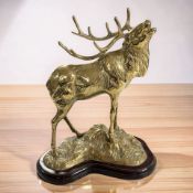 A cast brass figure of a stag on wooden plinth, height 30 cm.