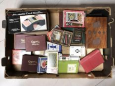 A quantity of playing cards in packs, automatic card shuffler,