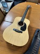 A Pearl River Model 014 acoustic guitar.