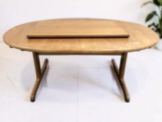 A 20th century G-Plan teak oval extending dining table, with leaf, overall 220 cm x 100 cm x 74 cm.