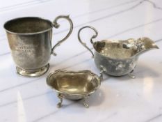 A small silver cream jug, height 7cm, together with a silver mug and a salt.