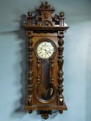 A 19th century walnut Vienna eight day wall clock, single weight driven movement, with pendulum,
