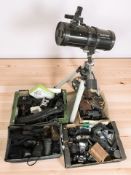 A Celstron POwer 127 eQ telescope and four boxes of vintage and modern cameras including Nikon,