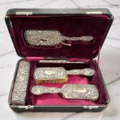 A Victorian silver-backed five piece dressing table set, Birmingham 1897, longest piece 25cm, cased.