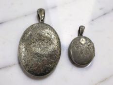 Two antique silver lockets, largest 5 cm x 4 cm.