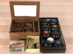 A set of carpet bowls, wooden dominoes in box,