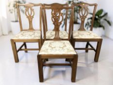 A set of four reproduction mahogany dining chairs.