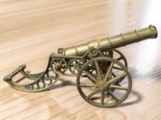 A brass model of a cannon on carriage, length 35 cm.