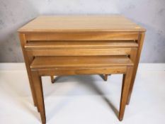 A 20th century teak nest of three tables, width 60 cm.