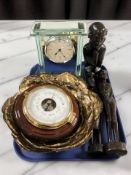 A group of African carved figures, reproduction barometer, glass quartz mantel clock, etc.
