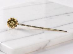 A Victorian stick pin set with a small diamond, stamped 15ct CONDITION REPORT: 1.