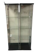 A pair of contemporary glass display cabinets, fitted shelves internally, each with keys,