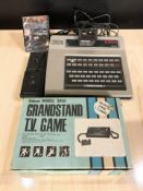 A Philips G7000 Videopac computer and an Adman Model 3000 Grandstand TV game.