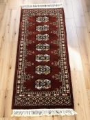 A small Turkoman runner, Afghanistan, 107 cm x 45 cm.