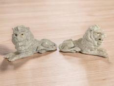 A pair of reproduction crackle glazed recumbent lions,