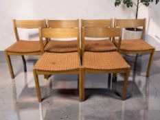 A set of six 20th century teak dining chairs with curved laminated back rests.