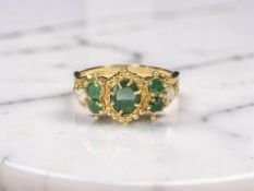 An emerald and diamond ring, stamped 18Ct, size N CONDITION REPORT: 4.