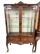 A reproduction mahogany glazed double door display cabinet on cabriole legs,