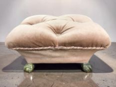 A pink draylon upholstered footstool in brass claw and ball feet, width 34 cm.
