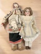 A German bisque headed doll, height 53 cm, and a further Russian cloth doll.