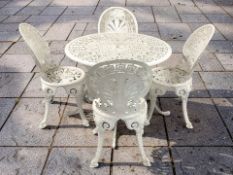 A painted aluminium garden patio table and four chairs, table 87 cm diameter.
