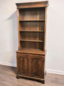 A reproduction mahogany bookcase, fitted cupboards beneath, width 76 cm.