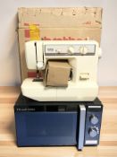 A Brother VX-1120 electric sewing machine and a Russell Hobbs microwave.