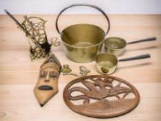 A Victorian brass jam pan, two graduated saucepans, companion set, wooden carvings, etc.